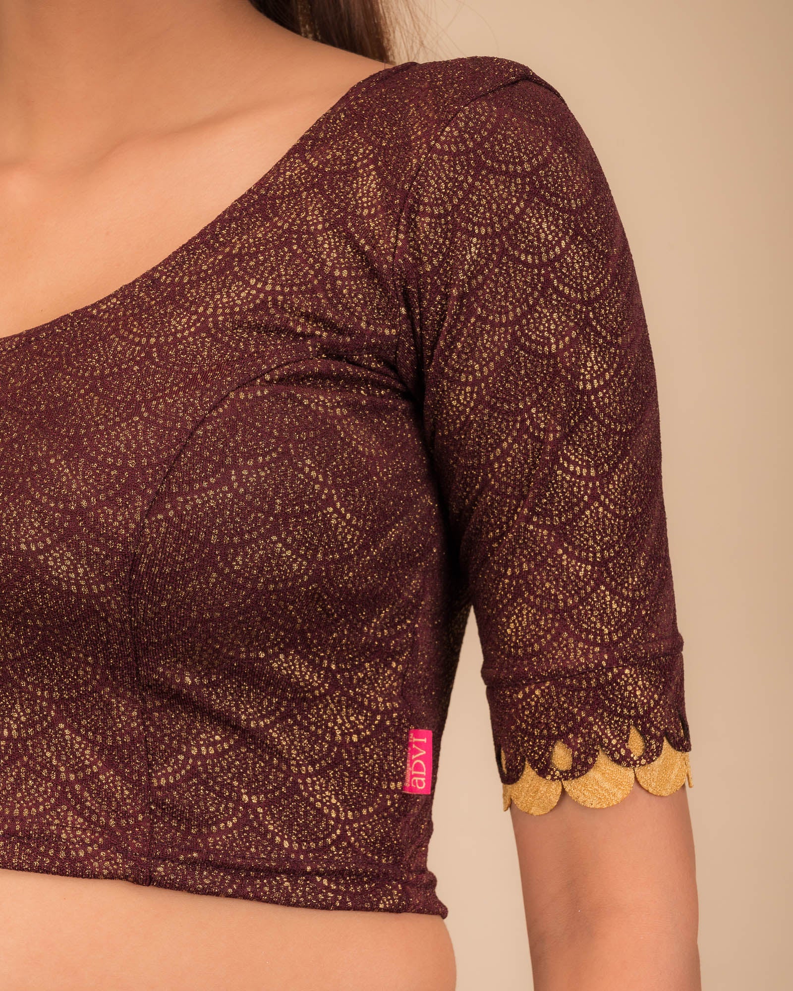 Close-up of the jacquard knit fabric with metallic scallop detailing.