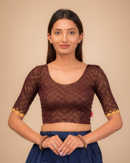 Model wearing a stretchable blouse with scallop-edged elbow sleeves and round neckline.