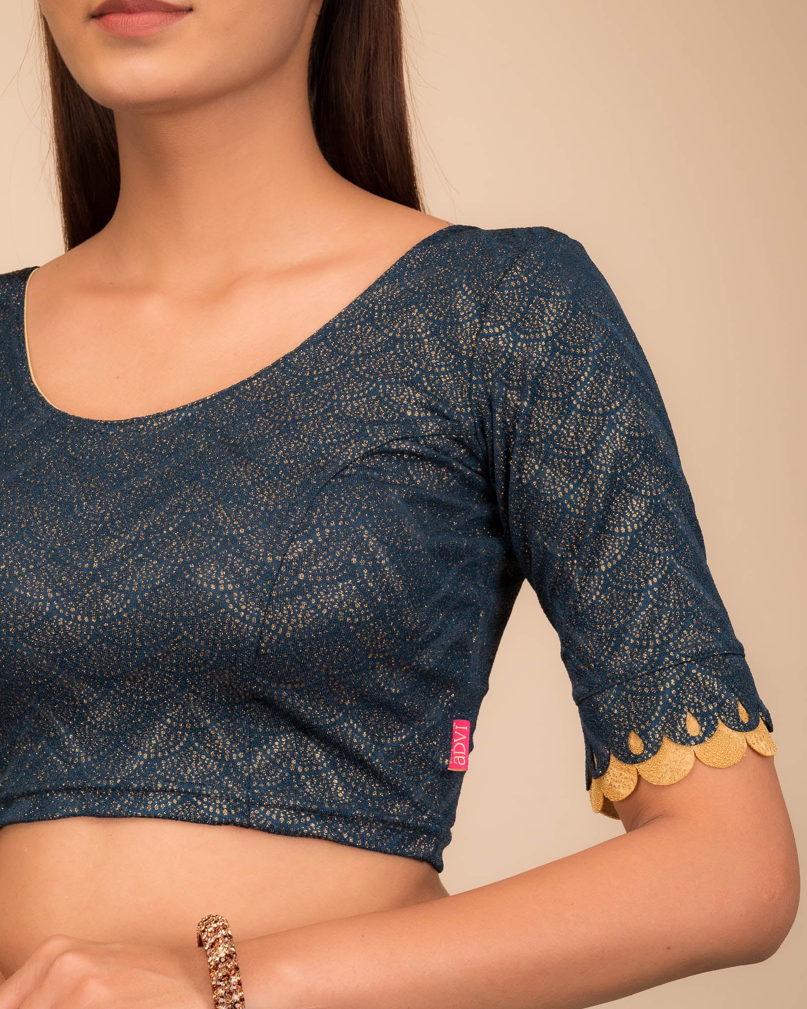Close-up of the jacquard knit fabric with metallic scallop detailing.