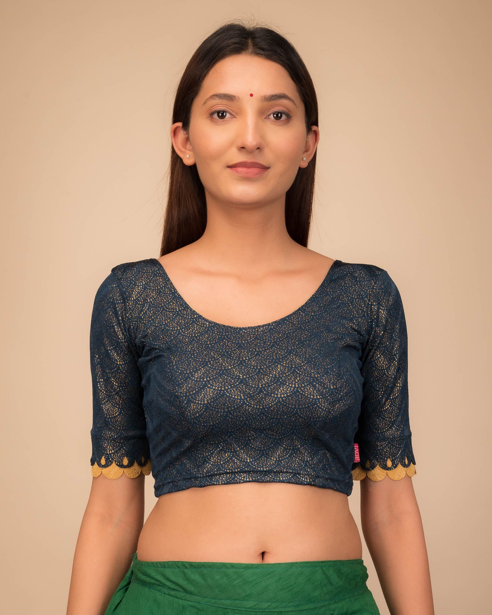 Model wearing a stretchable blouse with scallop-edged elbow sleeves and round neckline.
