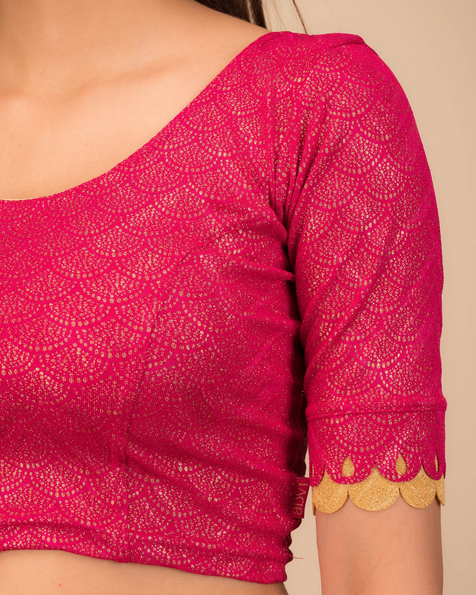 Close-up of the jacquard knit fabric with metallic scallop detailing.