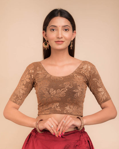 Model wearing a stretchable lurex blouse with elbow sleeves and round neckline, featuring delicate emboss details.
