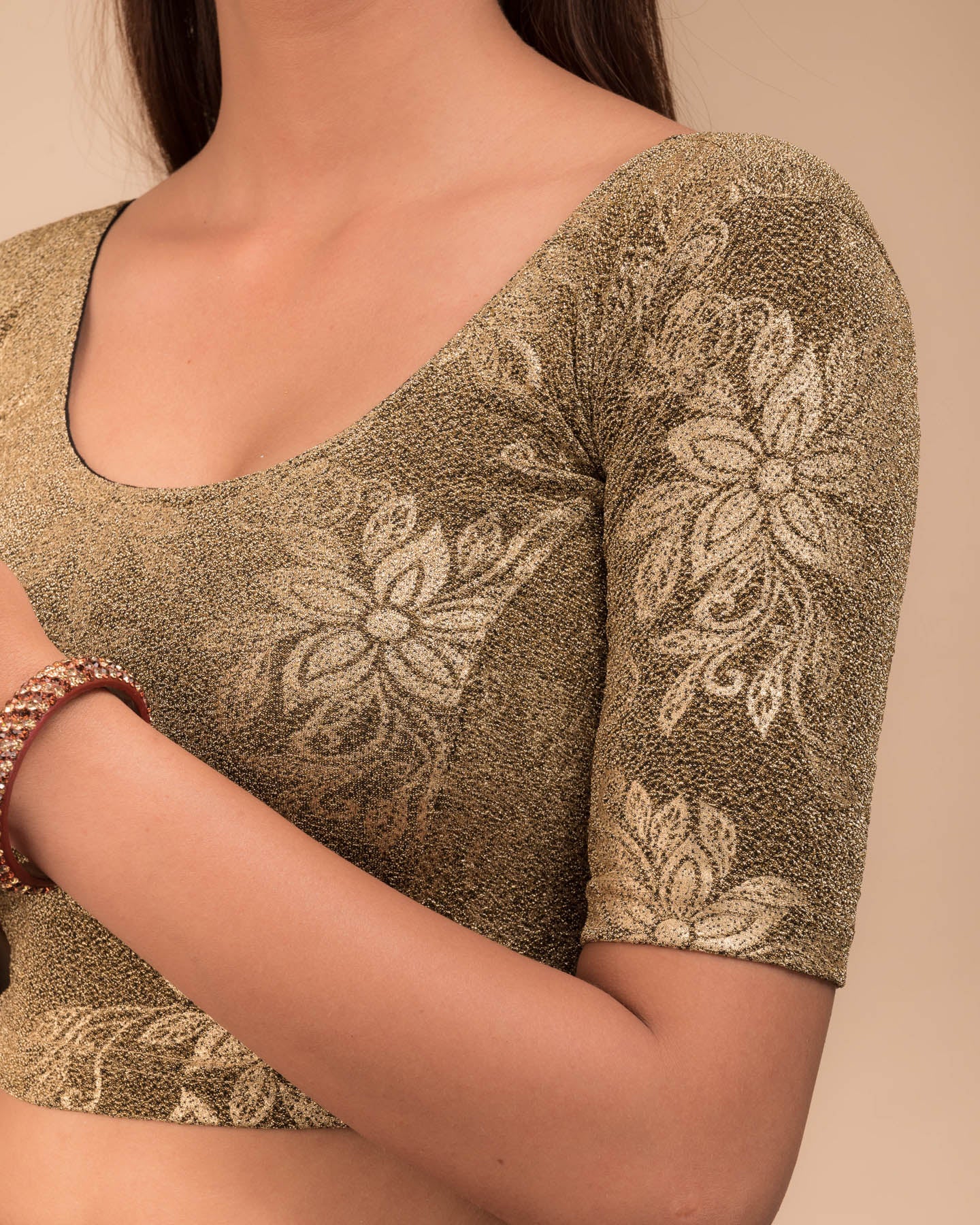 Close-up of the embossed metallic texture on stretchable knit fabric.