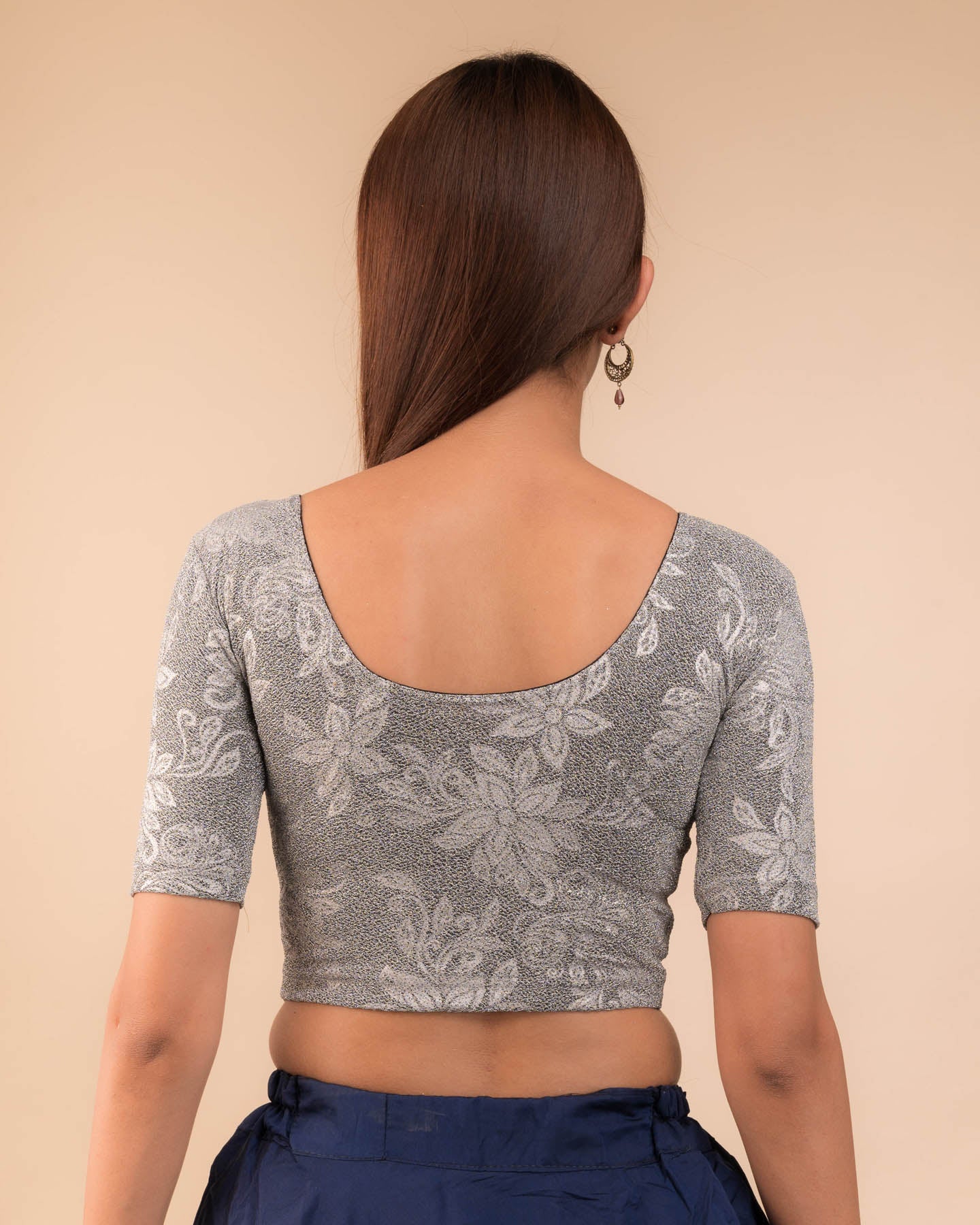 Rear view showcasing the metallic embossed pattern on the fabric.
