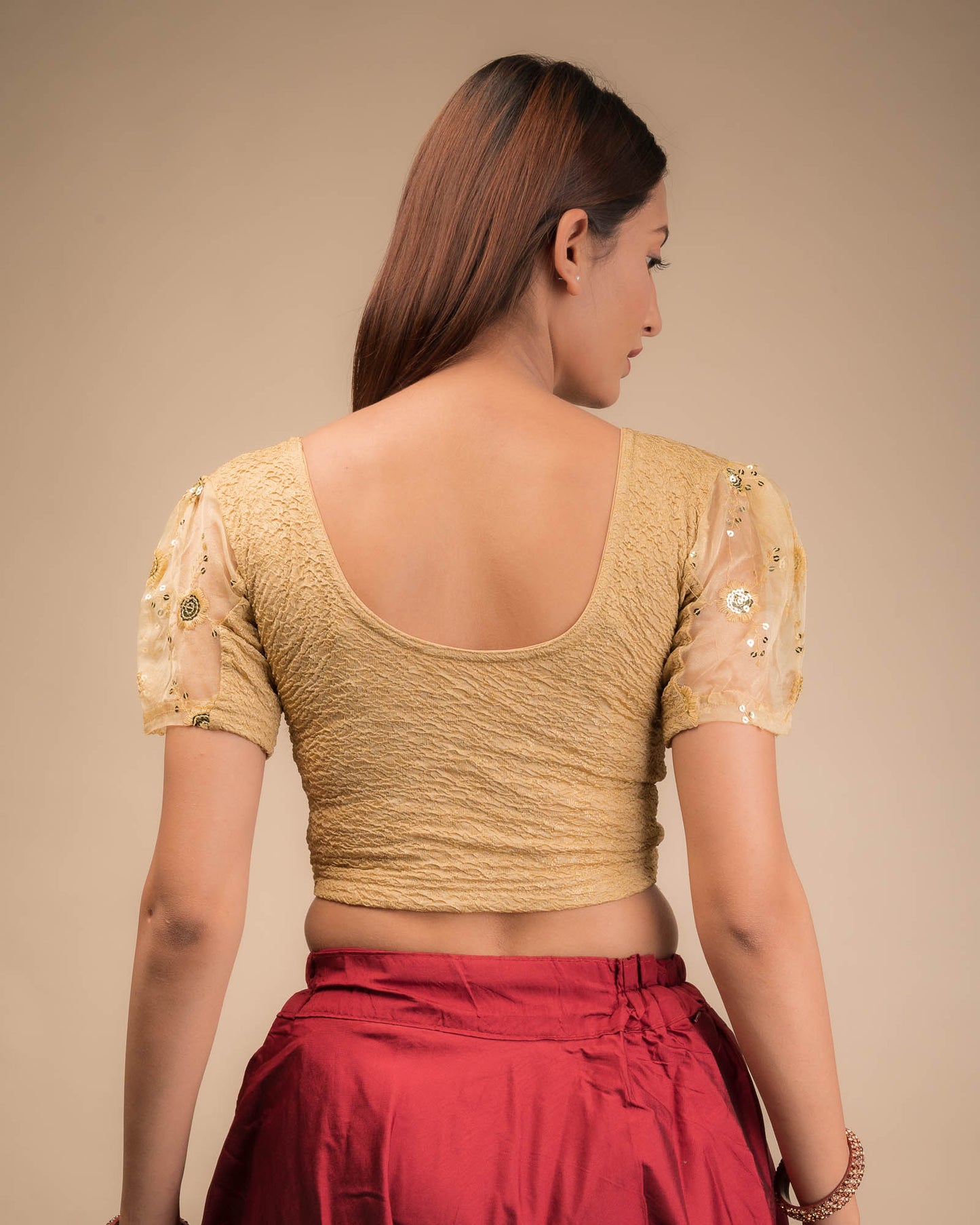 Rear view showcasing the blouse's back design and sleeve structure.