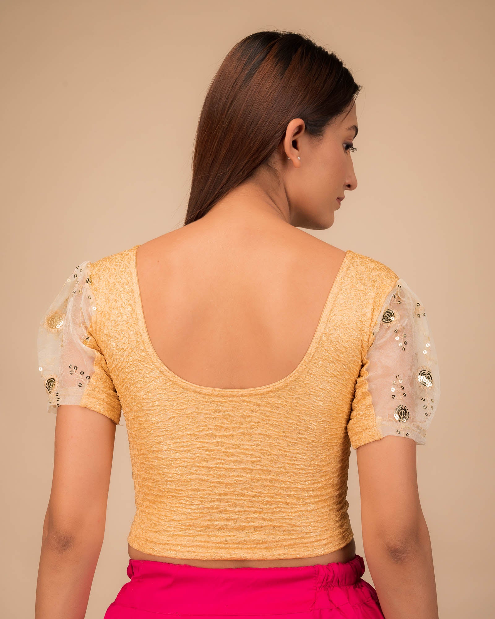 Rear view showcasing the blouse's back design and sleeve structure.