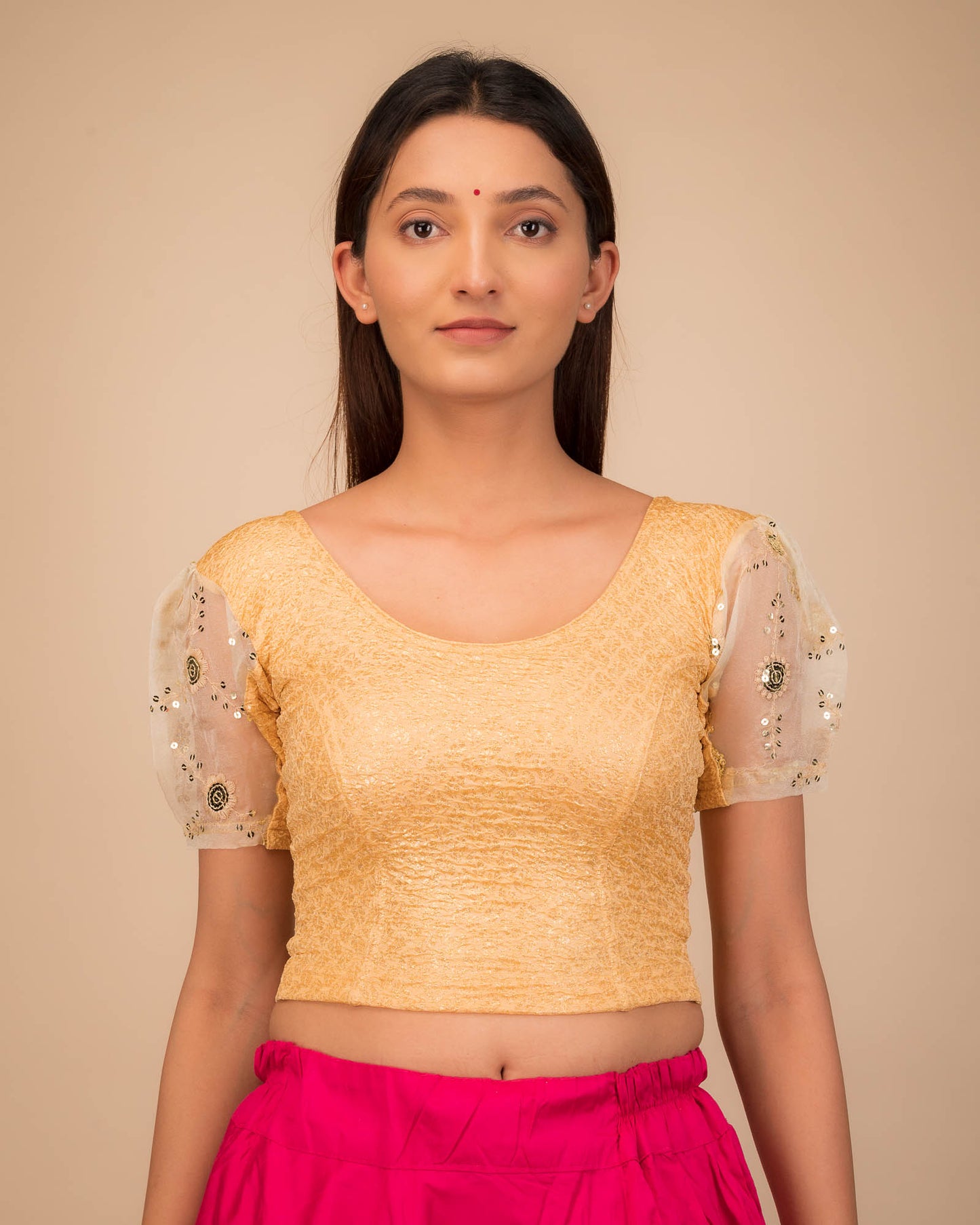 Model wearing a stretchable blouse with puff organza sleeves and round neckline.