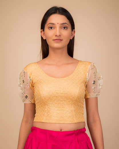 Model wearing a stretchable blouse with puff organza sleeves and round neckline.