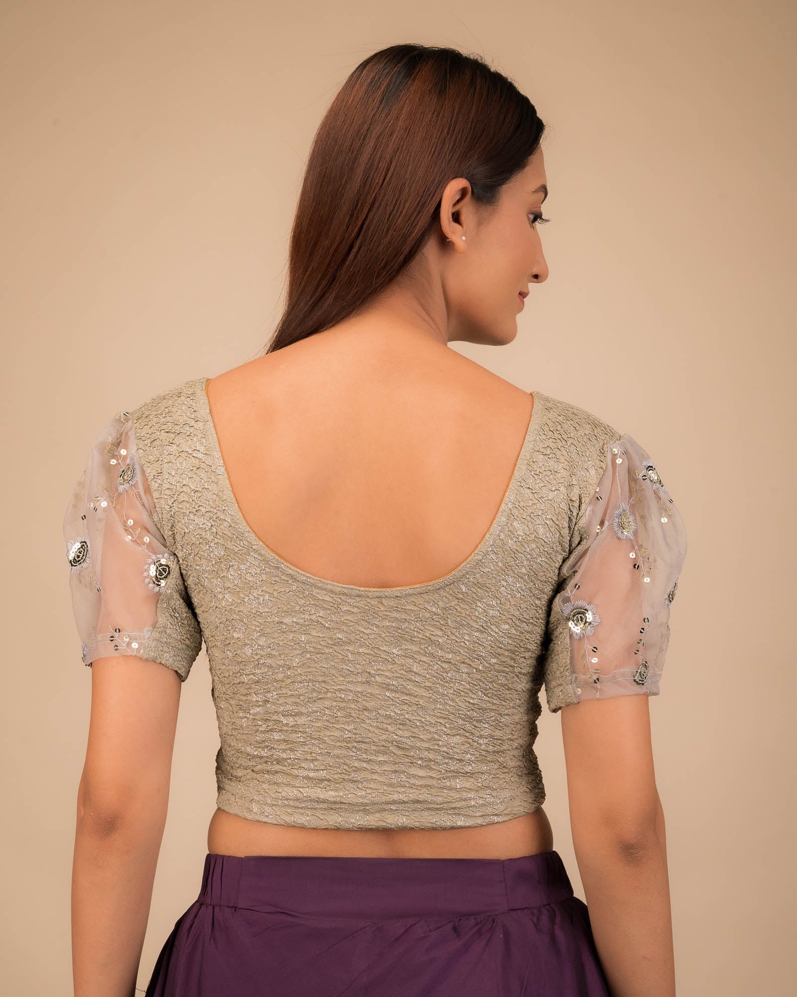 Rear view showcasing the blouse's back design and sleeve structure.