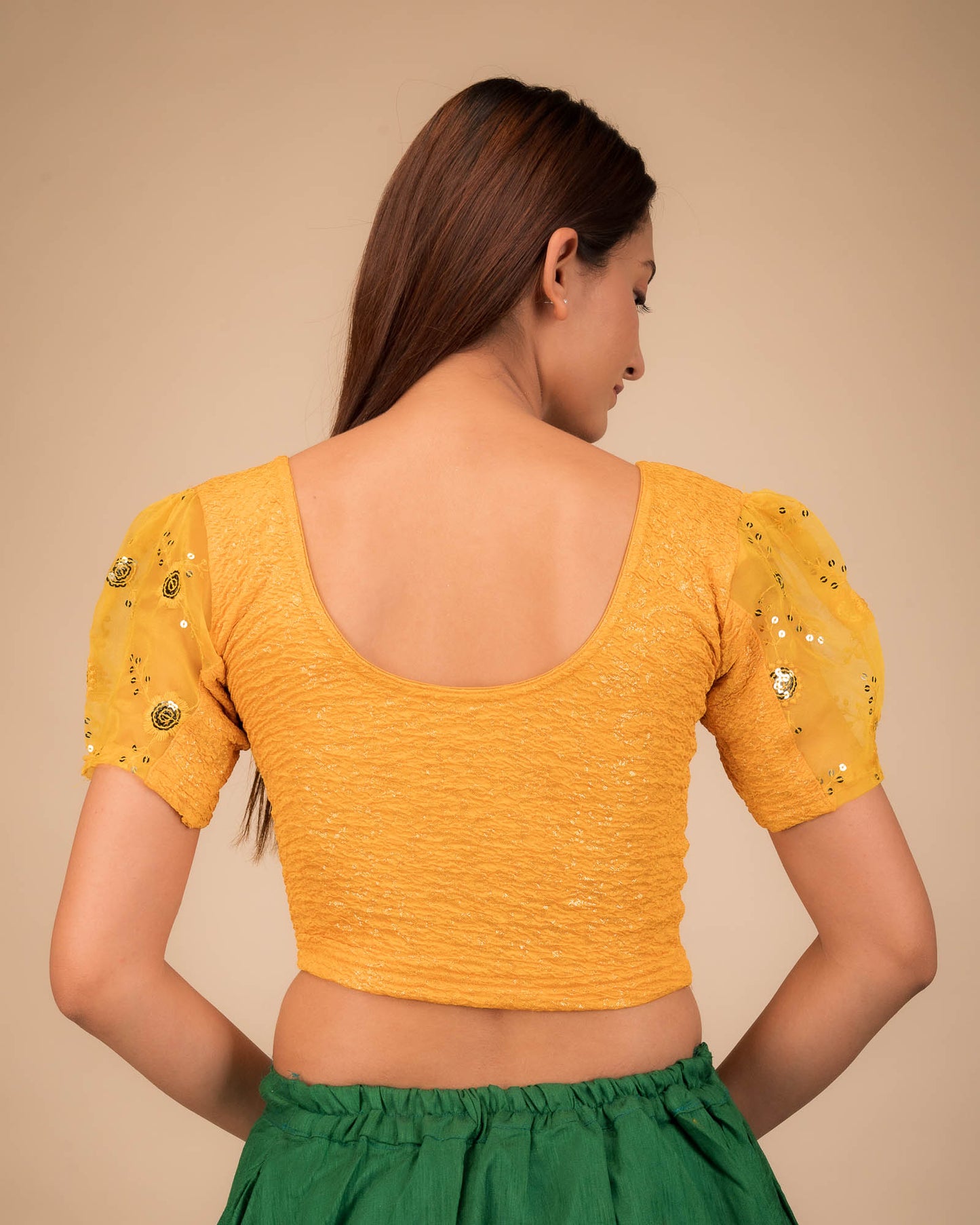 Rear view showcasing the blouse's back design and sleeve structure.