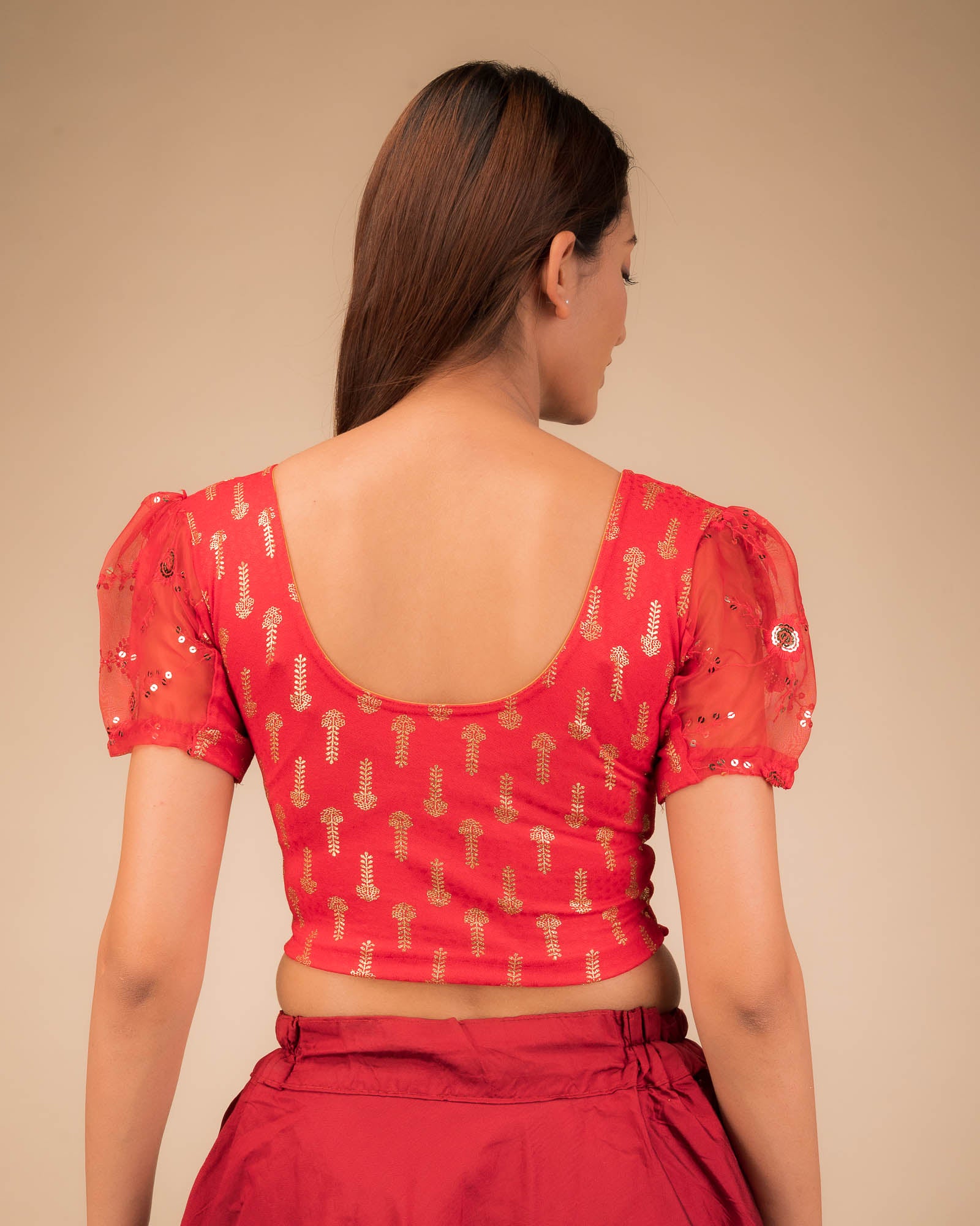 Rear view showcasing the blouse's back design and sleeve structure.