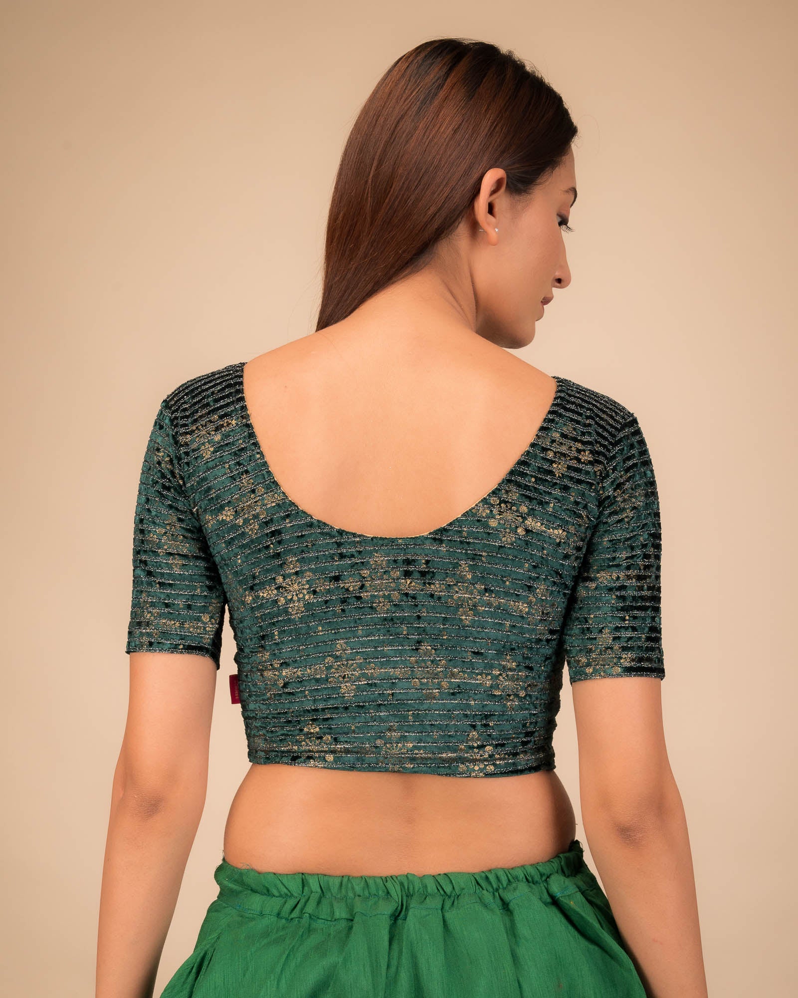 Rear view of the stretchable velvet blouse showcasing the back design.