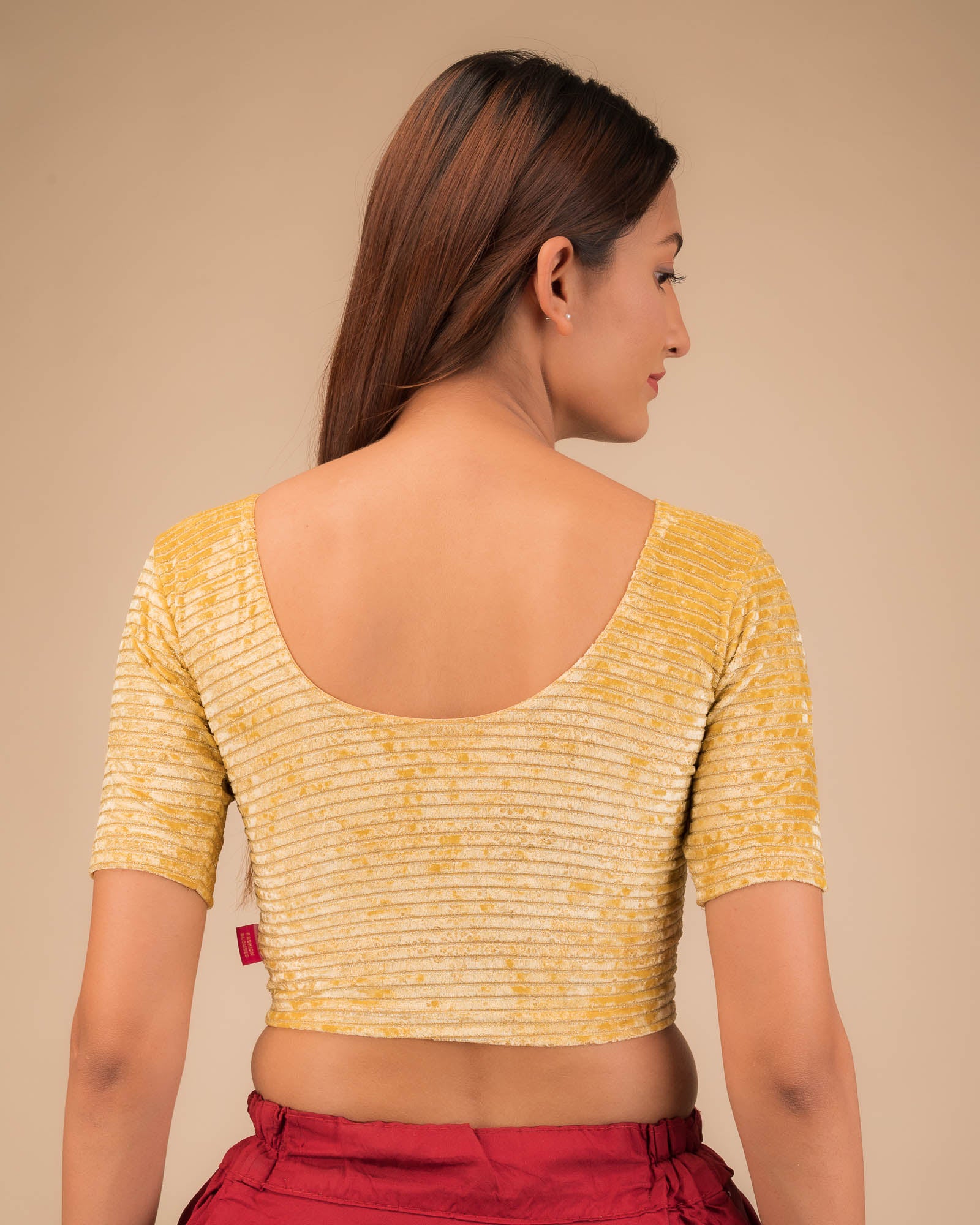 Rear view of the stretchable velvet blouse showcasing the back design.