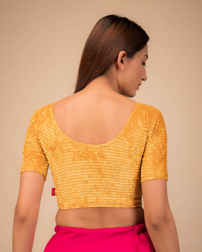 Rear view of the stretchable velvet blouse showcasing the back design.