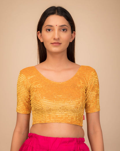 Model wearing a stretchable velvet blouse with elbow sleeves and round neckline.

