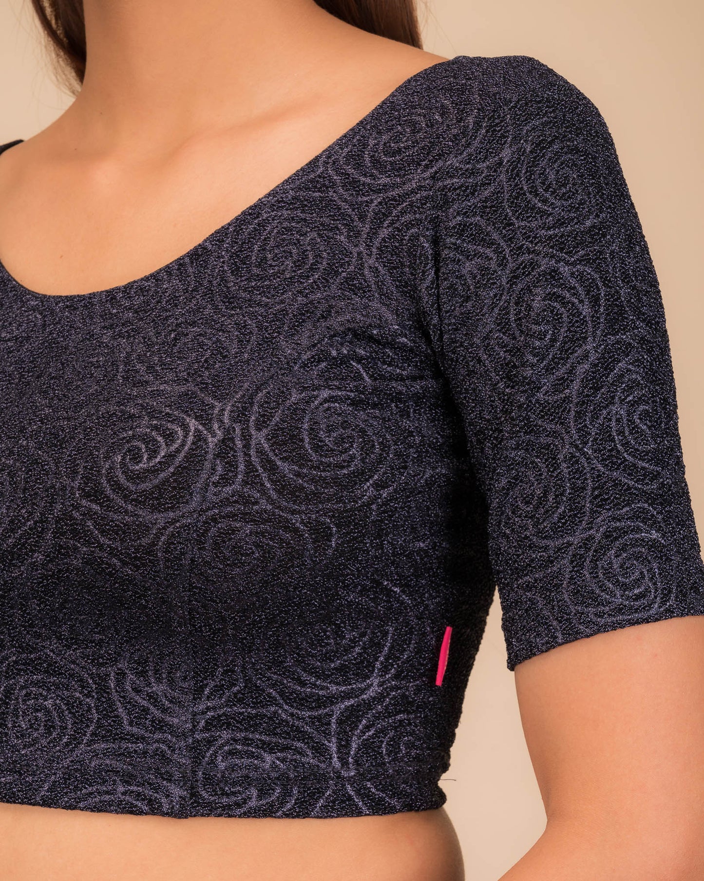 Close-up of the lurex knit fabric with embossed texture.