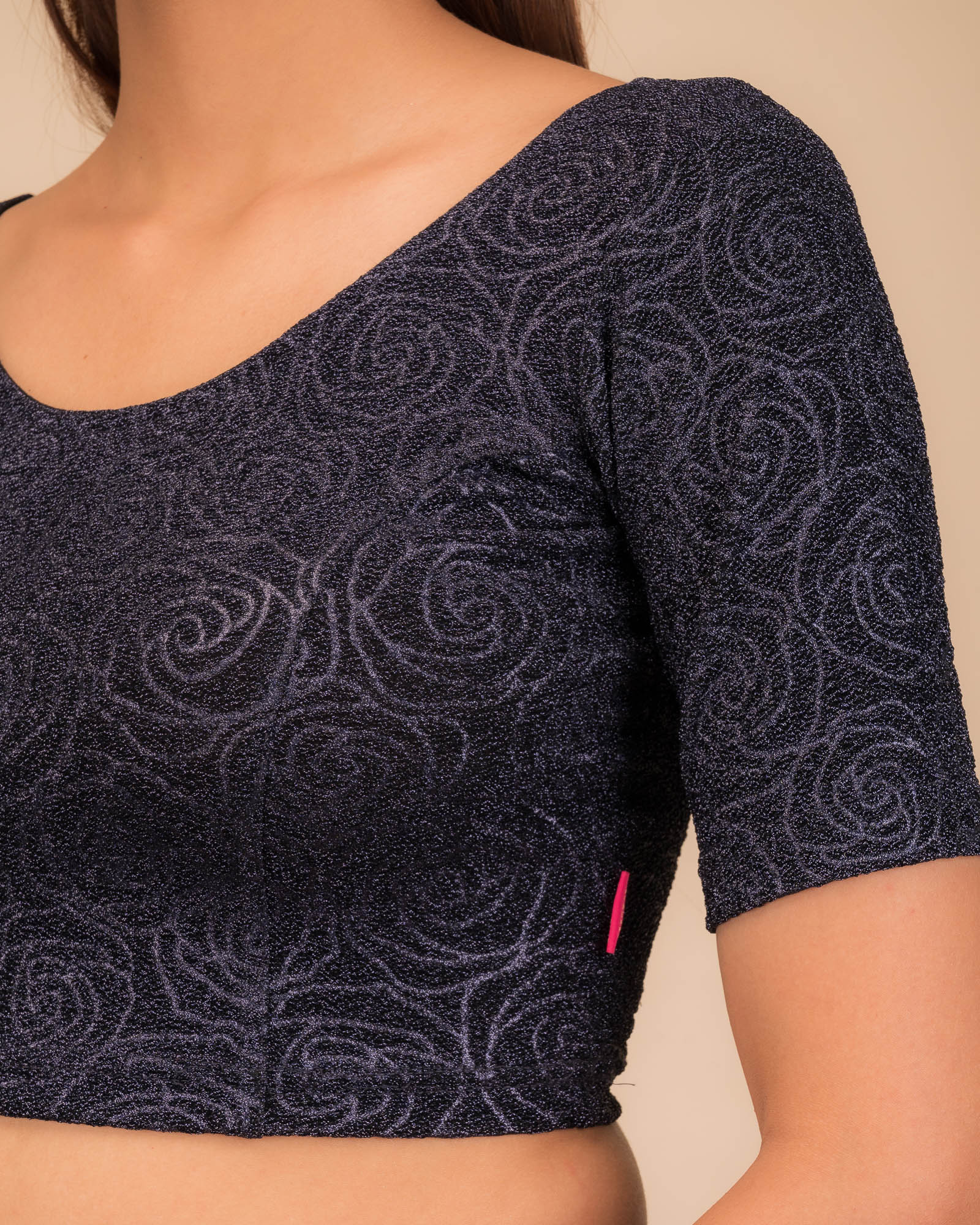 Close-up of the lurex knit fabric with embossed texture.