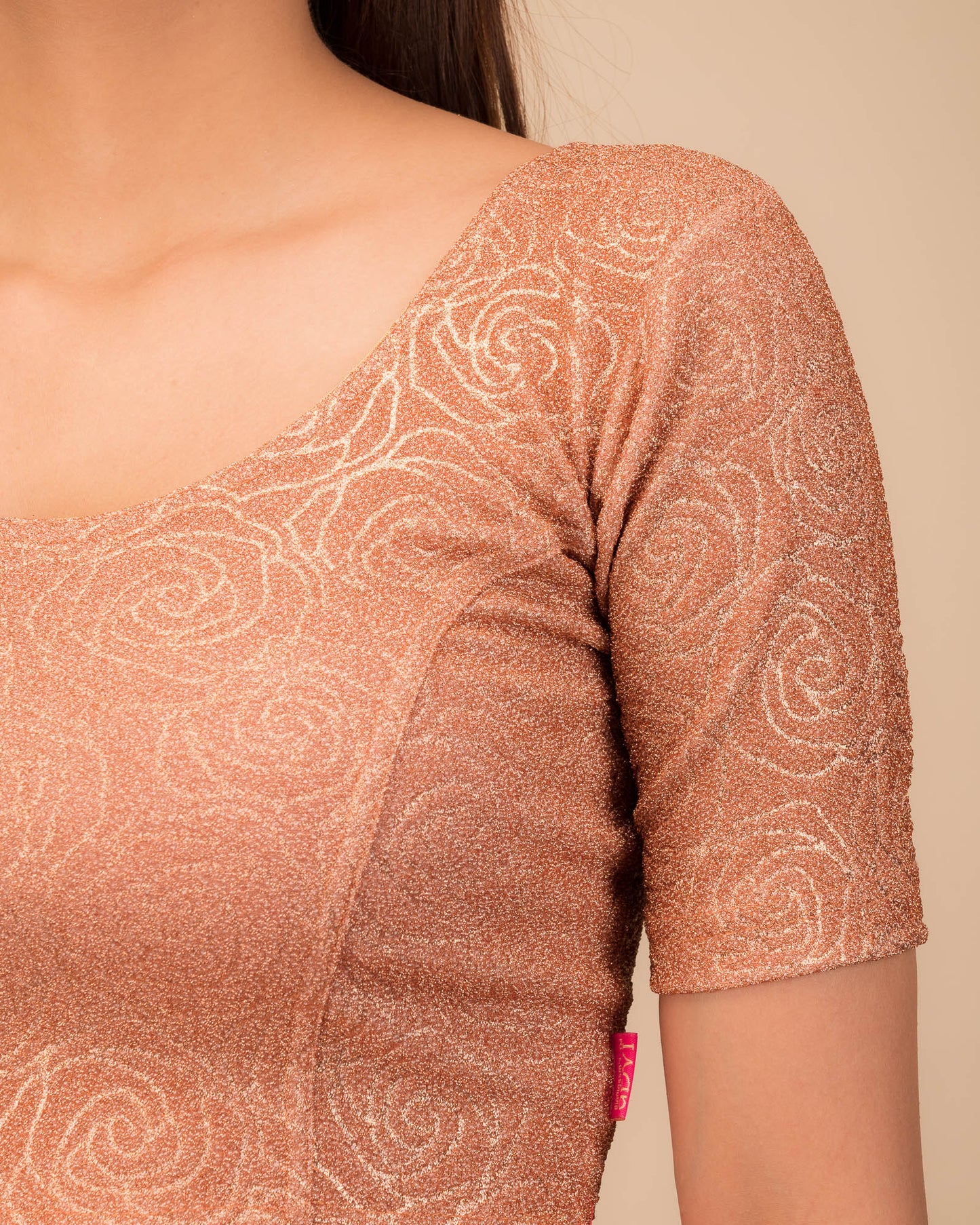 Close-up of the lurex knit fabric with embossed texture.