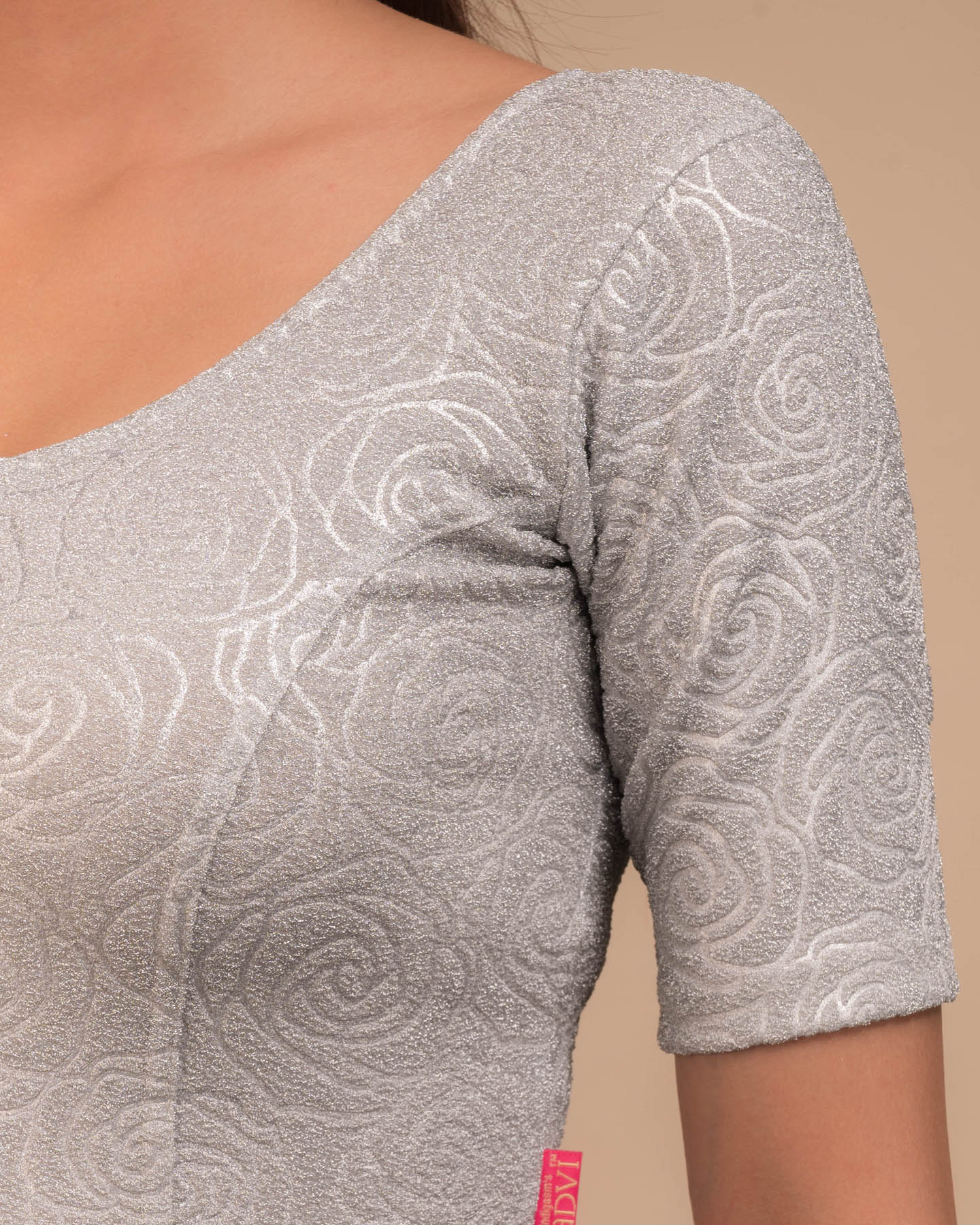 Close-up of the lurex knit fabric with embossed texture.