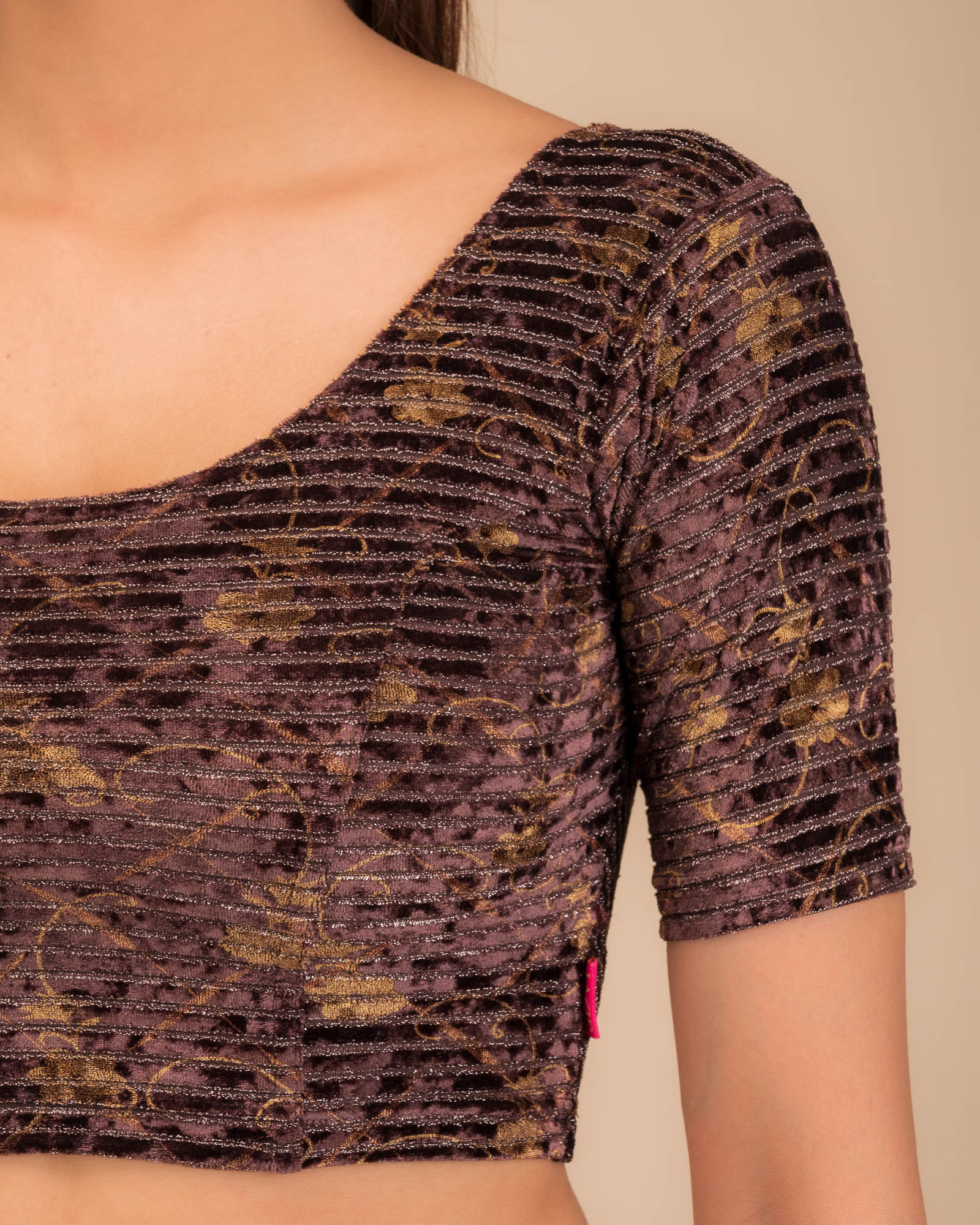 Close-up of velvet fabric with metallic stripe texture.