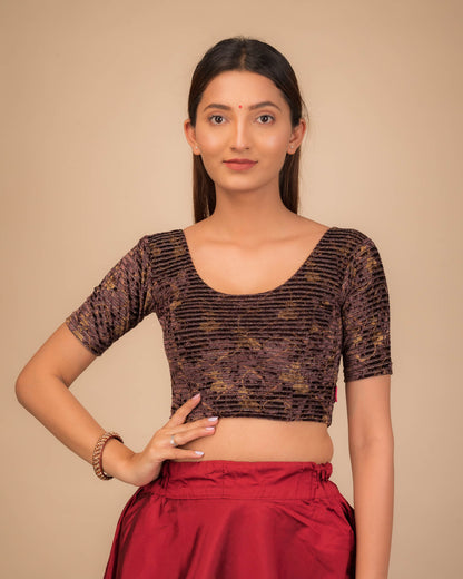 Model wearing a velvet stretchable blouse with elbow sleeves and round neckline.