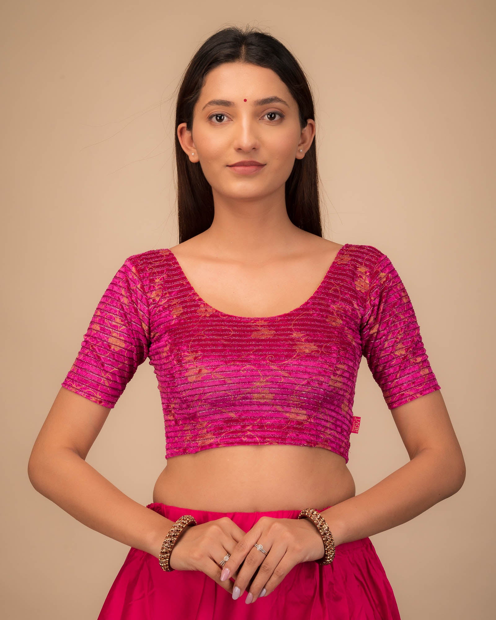 Model wearing a velvet stretchable blouse with elbow sleeves and round neckline.
