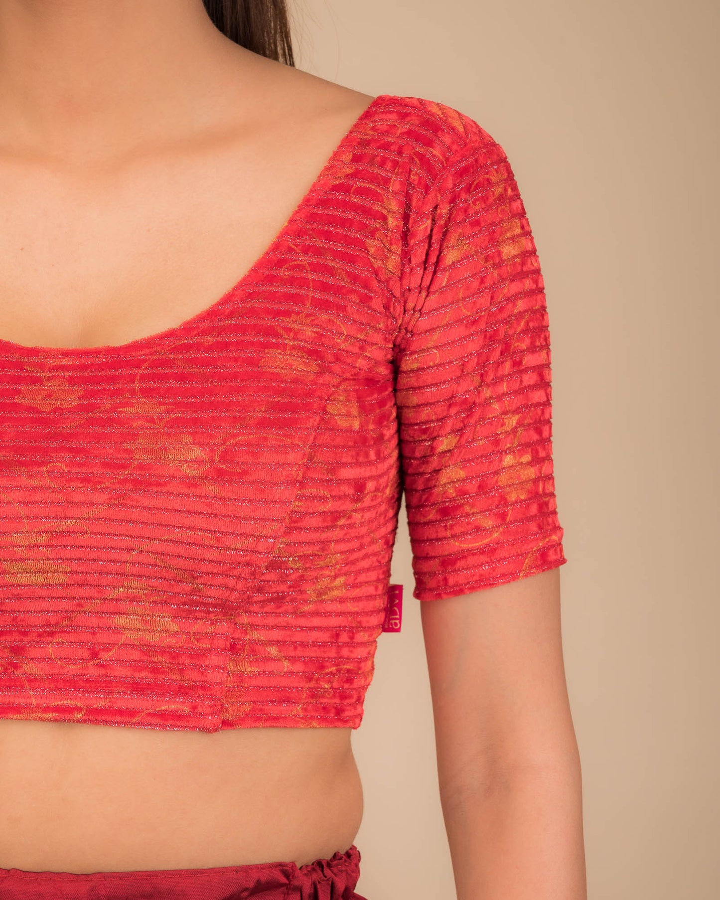 Close-up of velvet fabric with metallic stripe texture.
