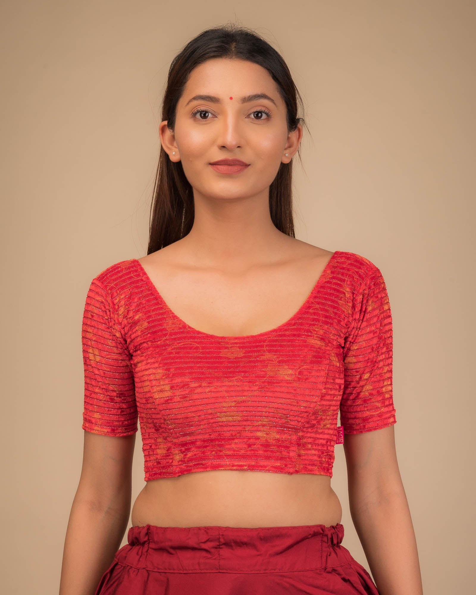 Model wearing a velvet stretchable blouse with elbow sleeves and round neckline.