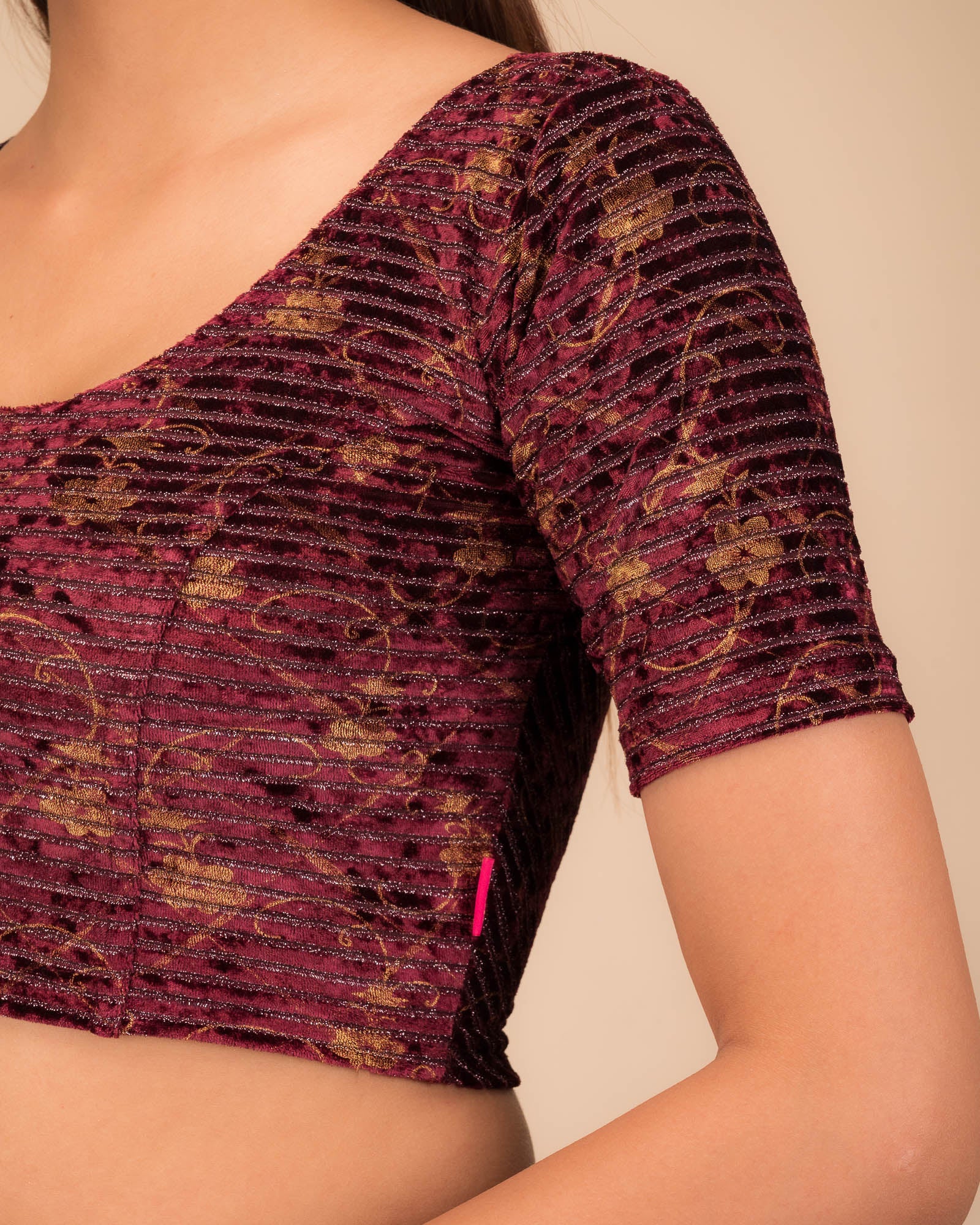 Close-up of velvet fabric with metallic stripe texture.