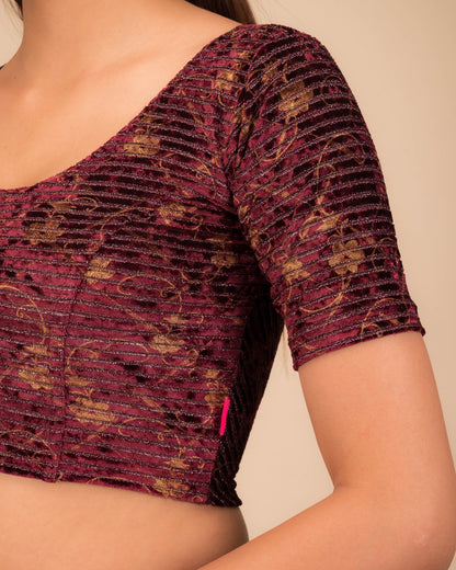 Close-up of velvet fabric with metallic stripe texture.