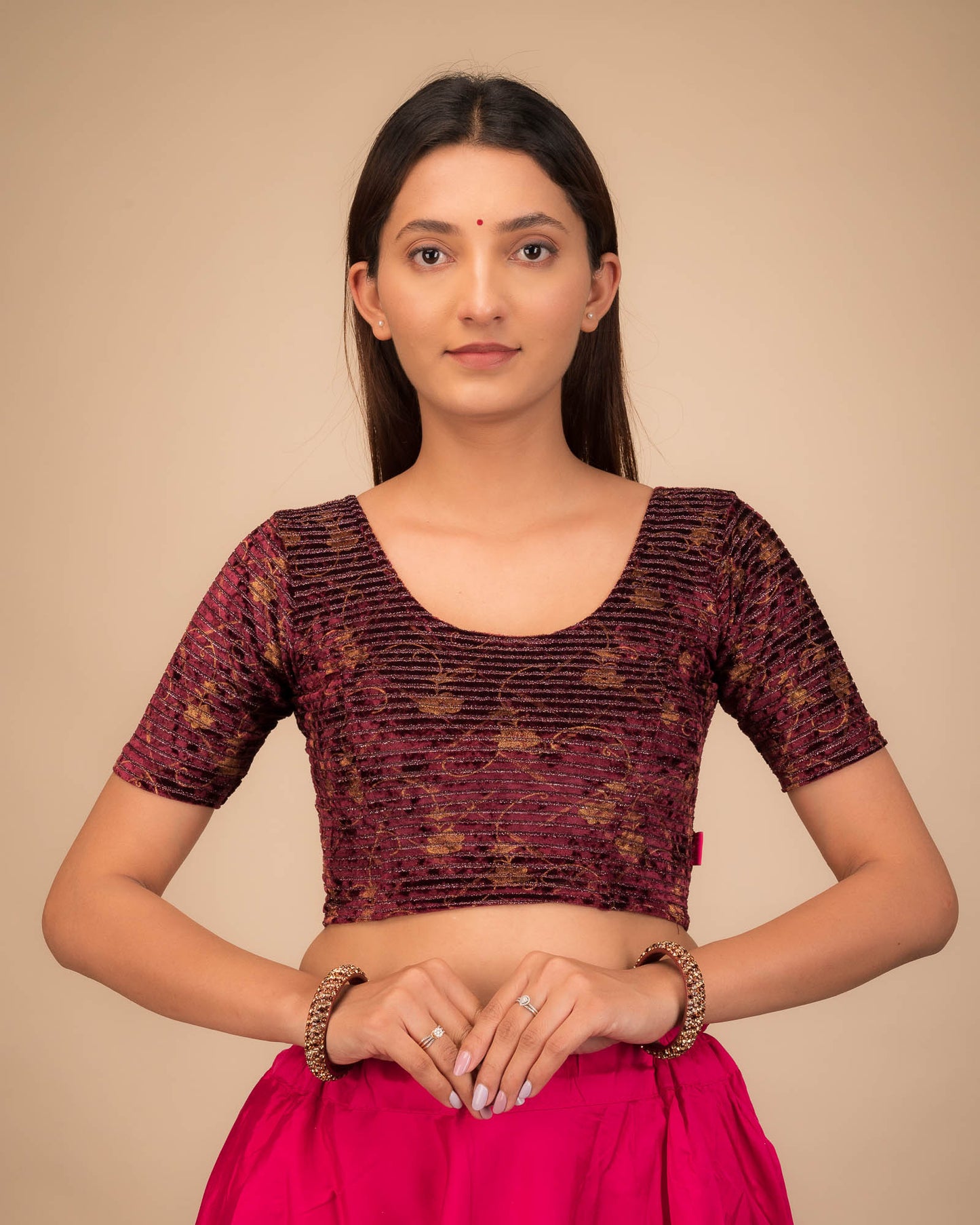 Model wearing a velvet stretchable blouse with elbow sleeves and round neckline.