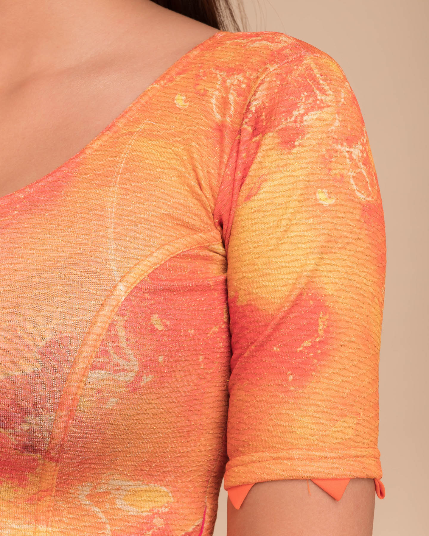 Close-up of jacquard fabric detailing the print and trims.
