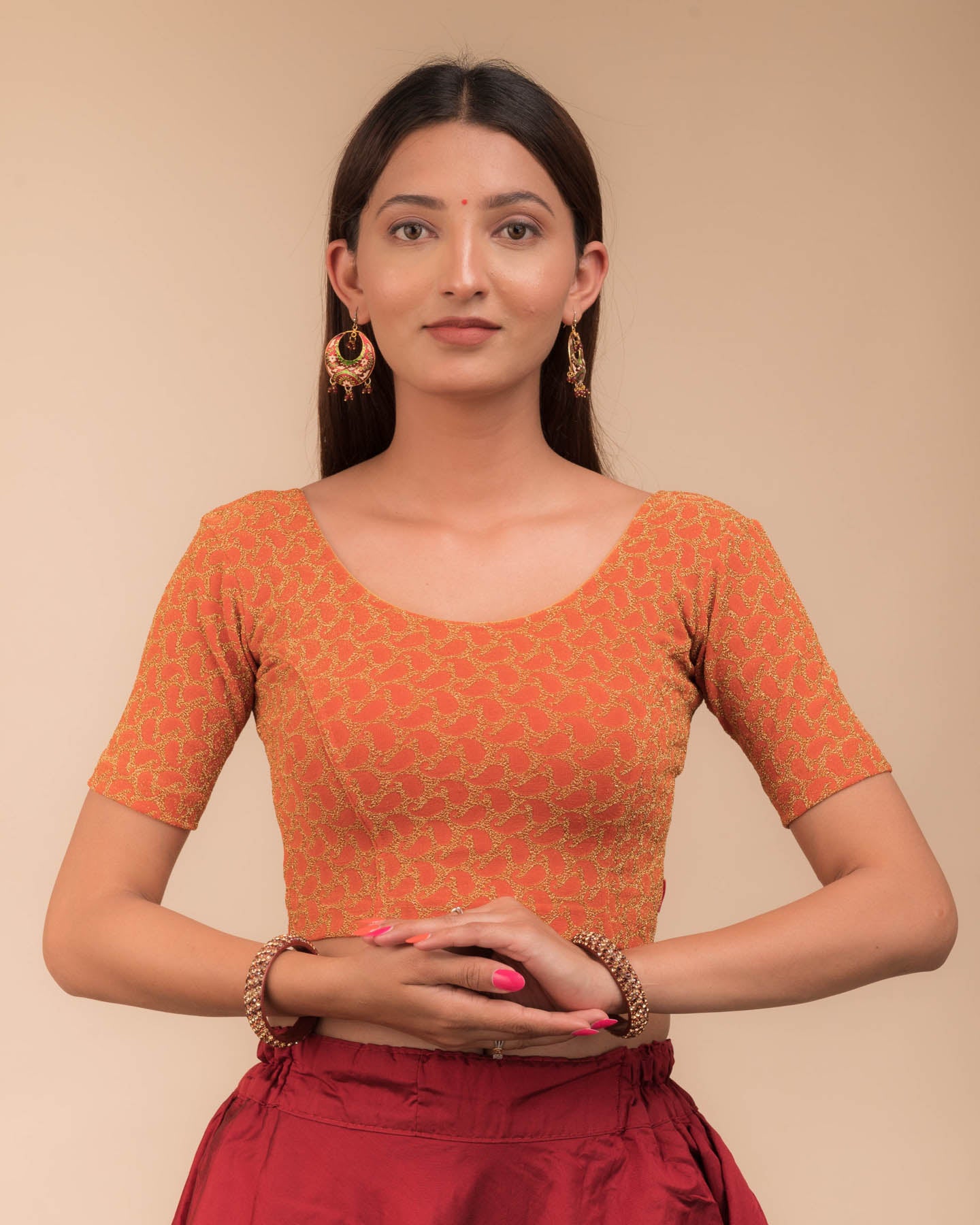 Model wearing a stretchable blouse with elbow sleeves and round neckline, featuring zari detailing