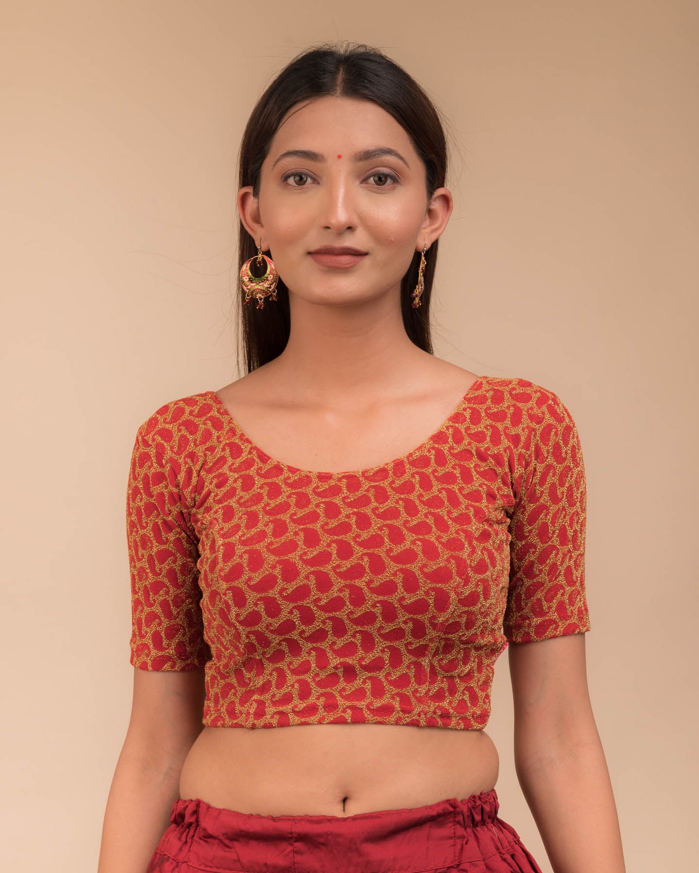 Model wearing a stretchable blouse with elbow sleeves and round neckline, featuring zari detailing.