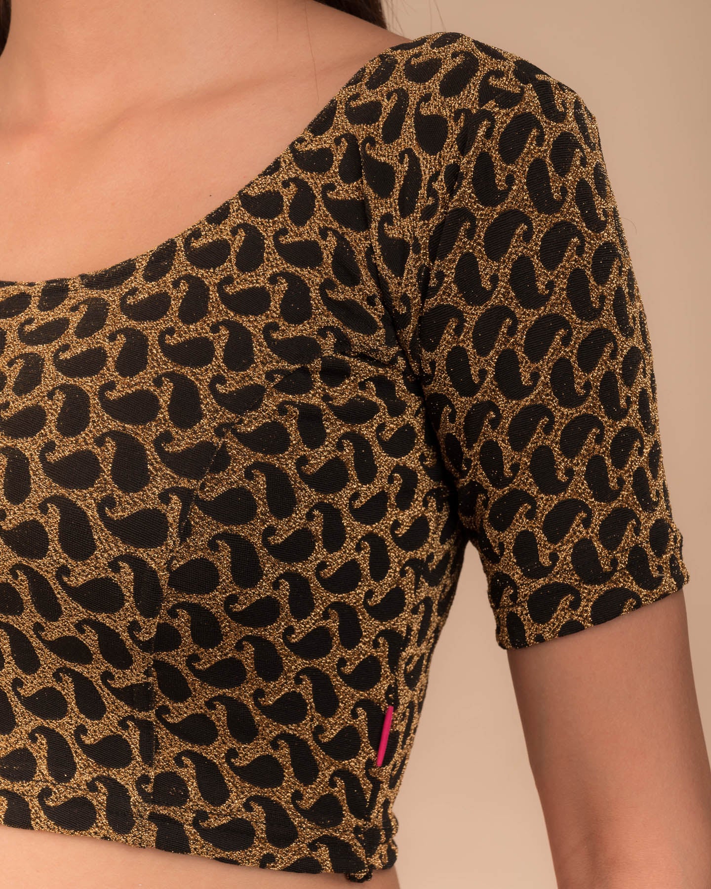 Close-up of jacquard fabric with zari pattern.