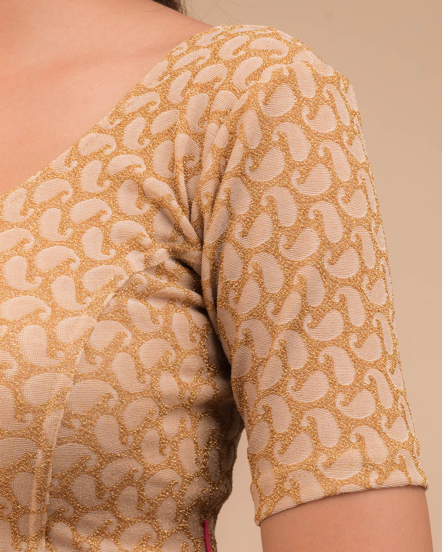 Close-up of jacquard fabric with zari pattern.