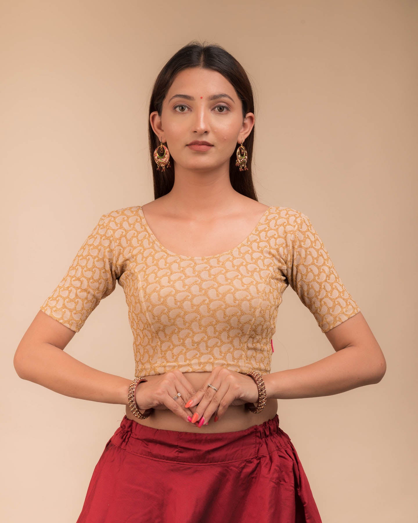 Model wearing a stretchable blouse with elbow sleeves and round neckline, featuring zari detailing.