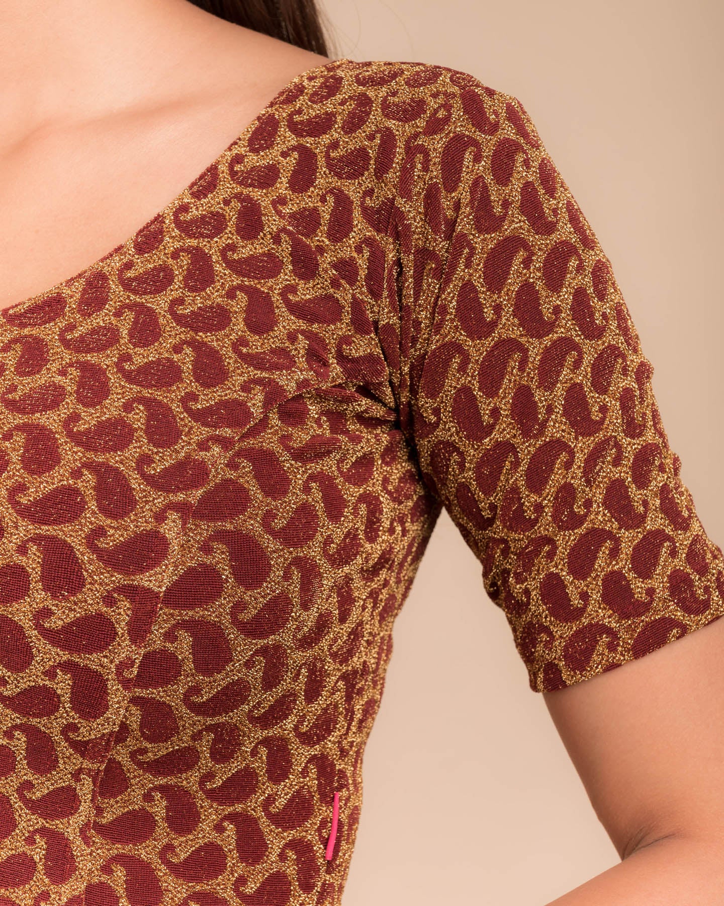 Close-up of jacquard fabric with zari pattern.