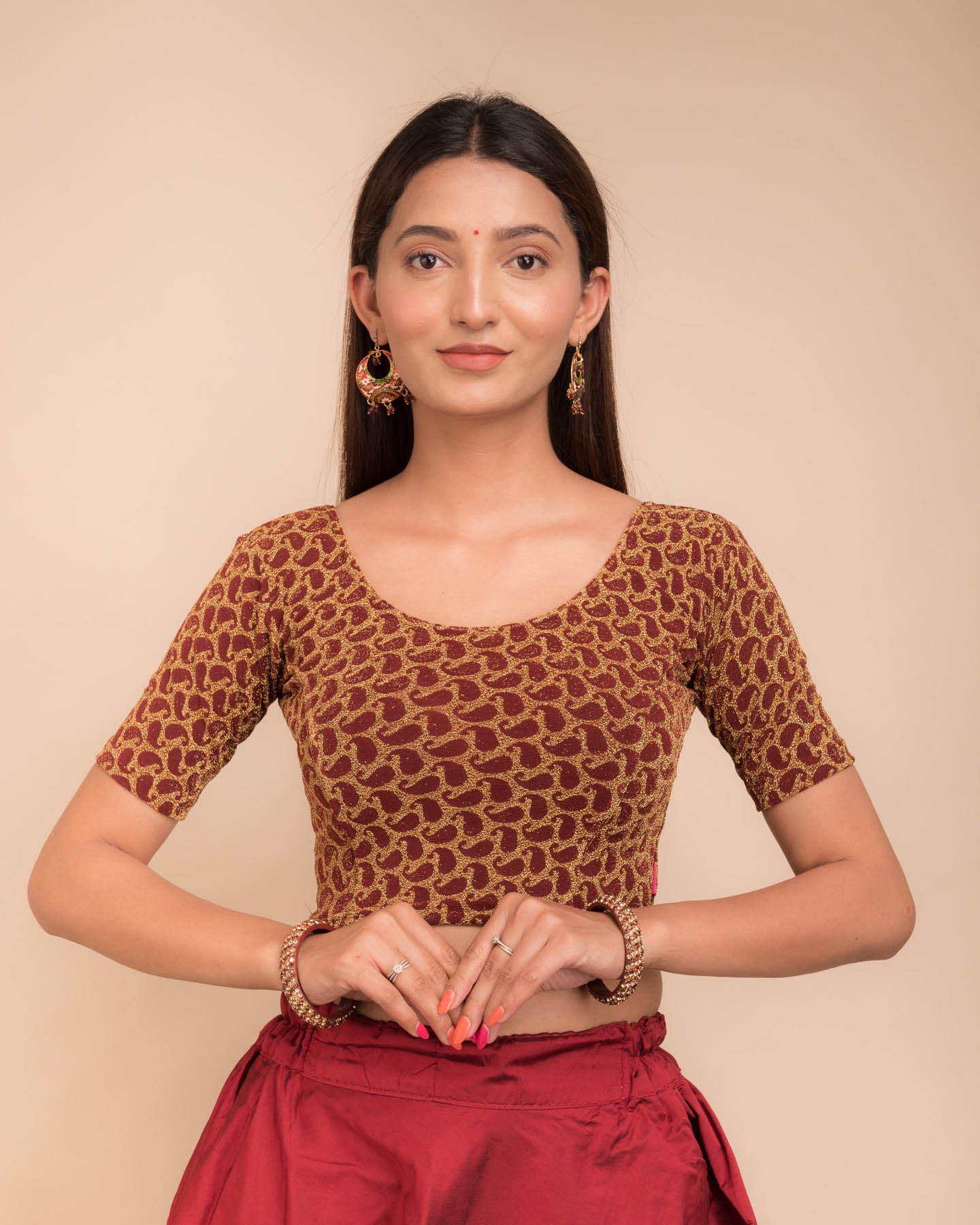 Model wearing a stretchable blouse with elbow sleeves and round neckline, featuring zari detailing.