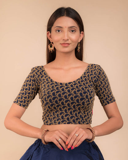 Model wearing a stretchable blouse with elbow sleeves and round neckline, featuring zari detailing.

