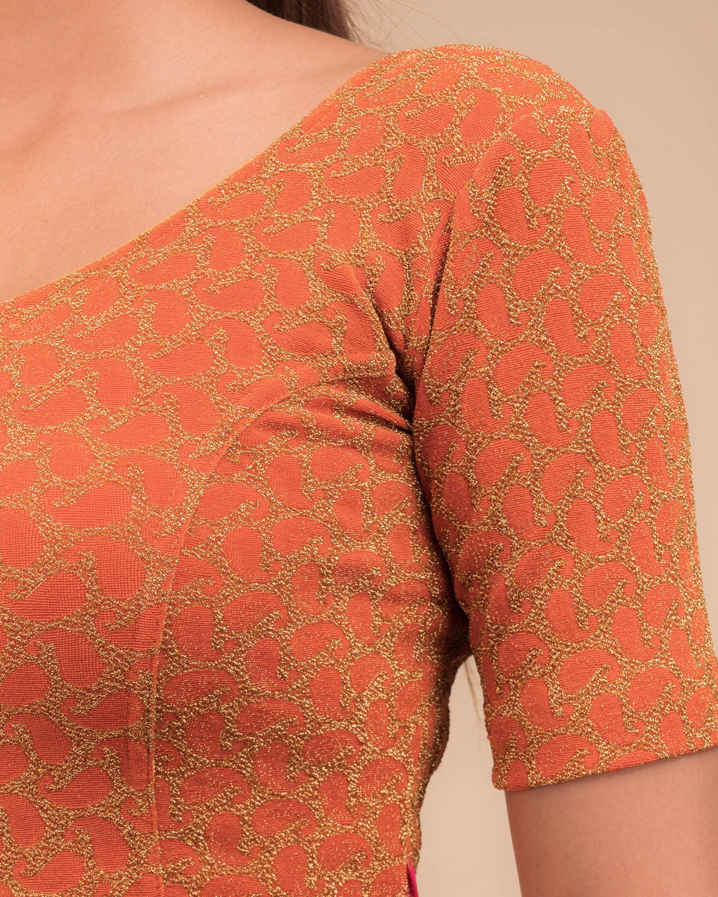 Close-up of jacquard fabric with zari pattern.