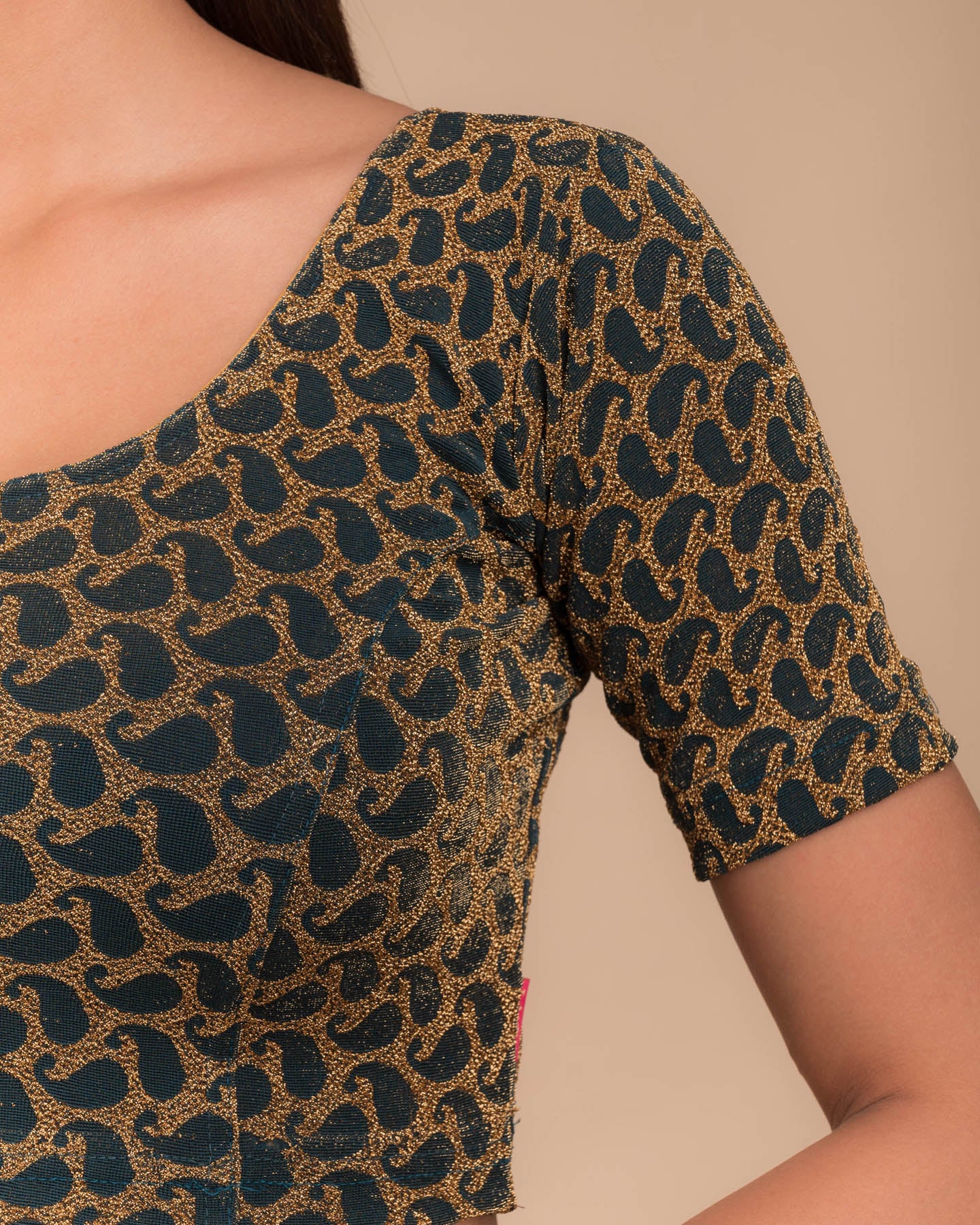 Close-up of jacquard fabric with zari pattern.
