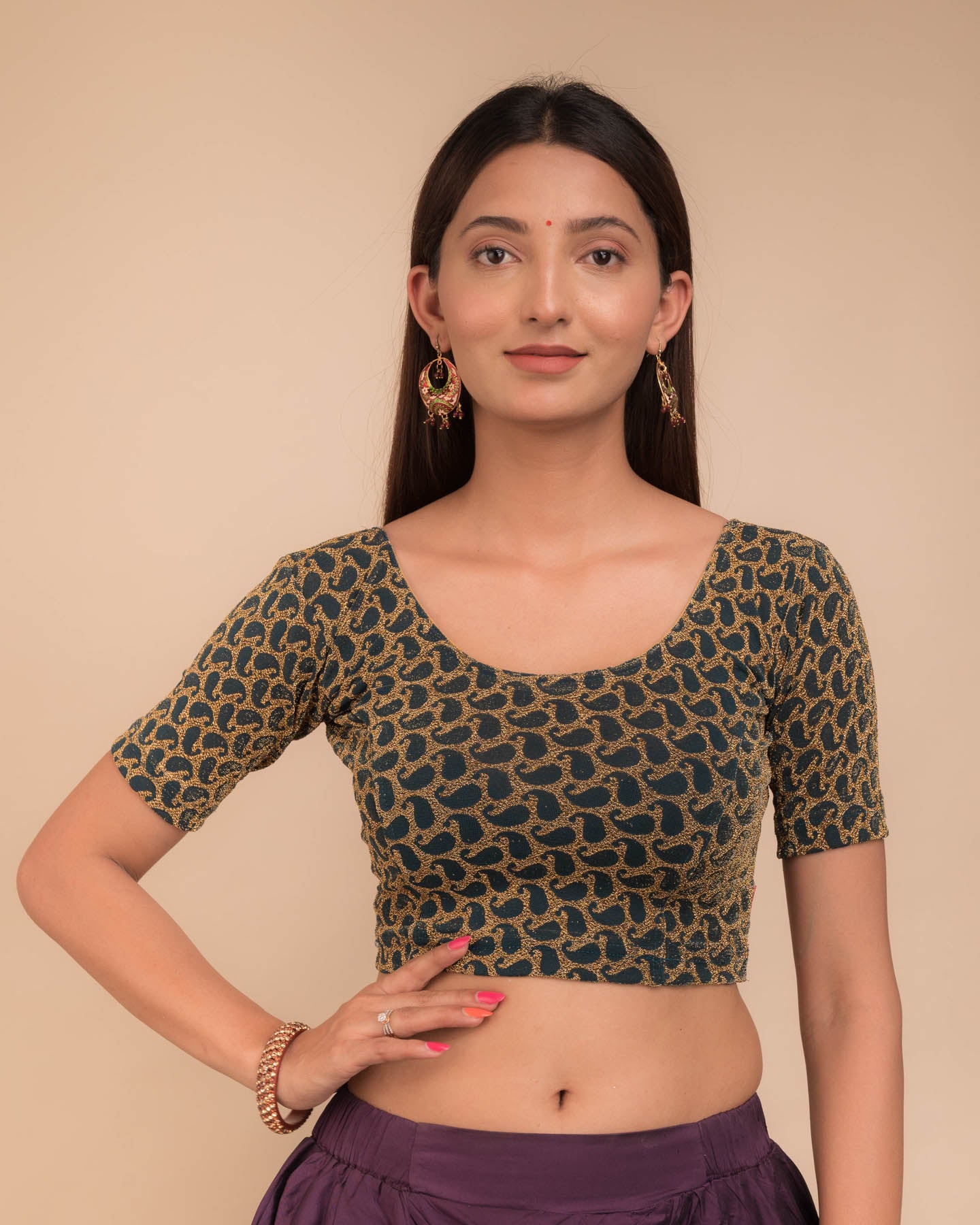 Model wearing a stretchable blouse with elbow sleeves and round neckline, featuring zari detailing.