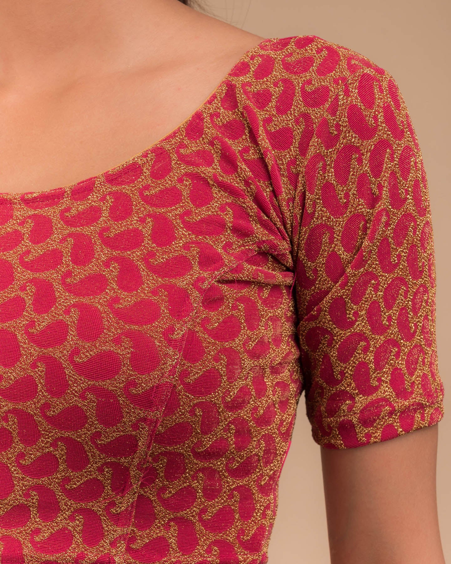 Close-up of jacquard fabric with zari pattern.
