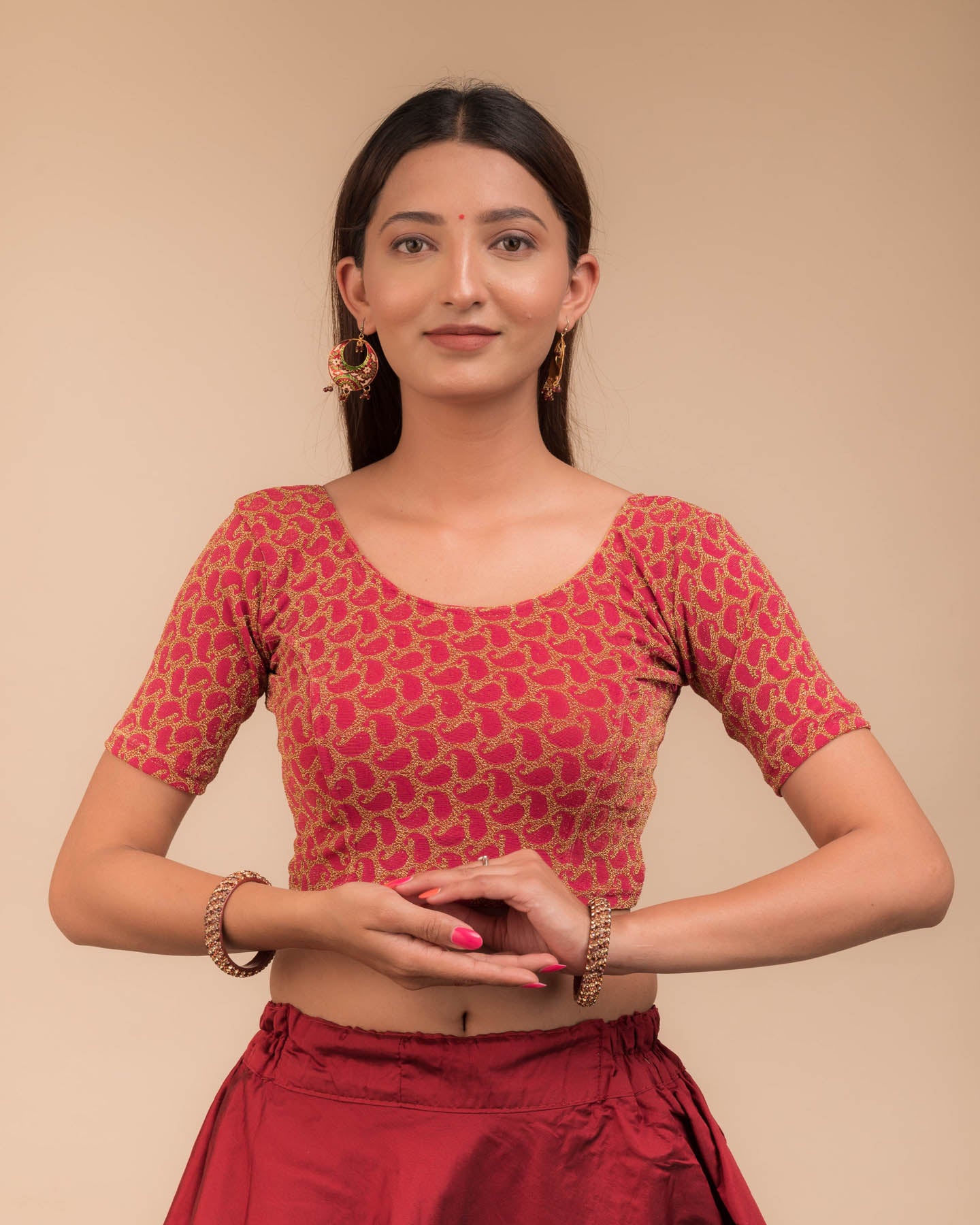 Model wearing a stretchable blouse with elbow sleeves and round neckline, featuring zari detailing.
