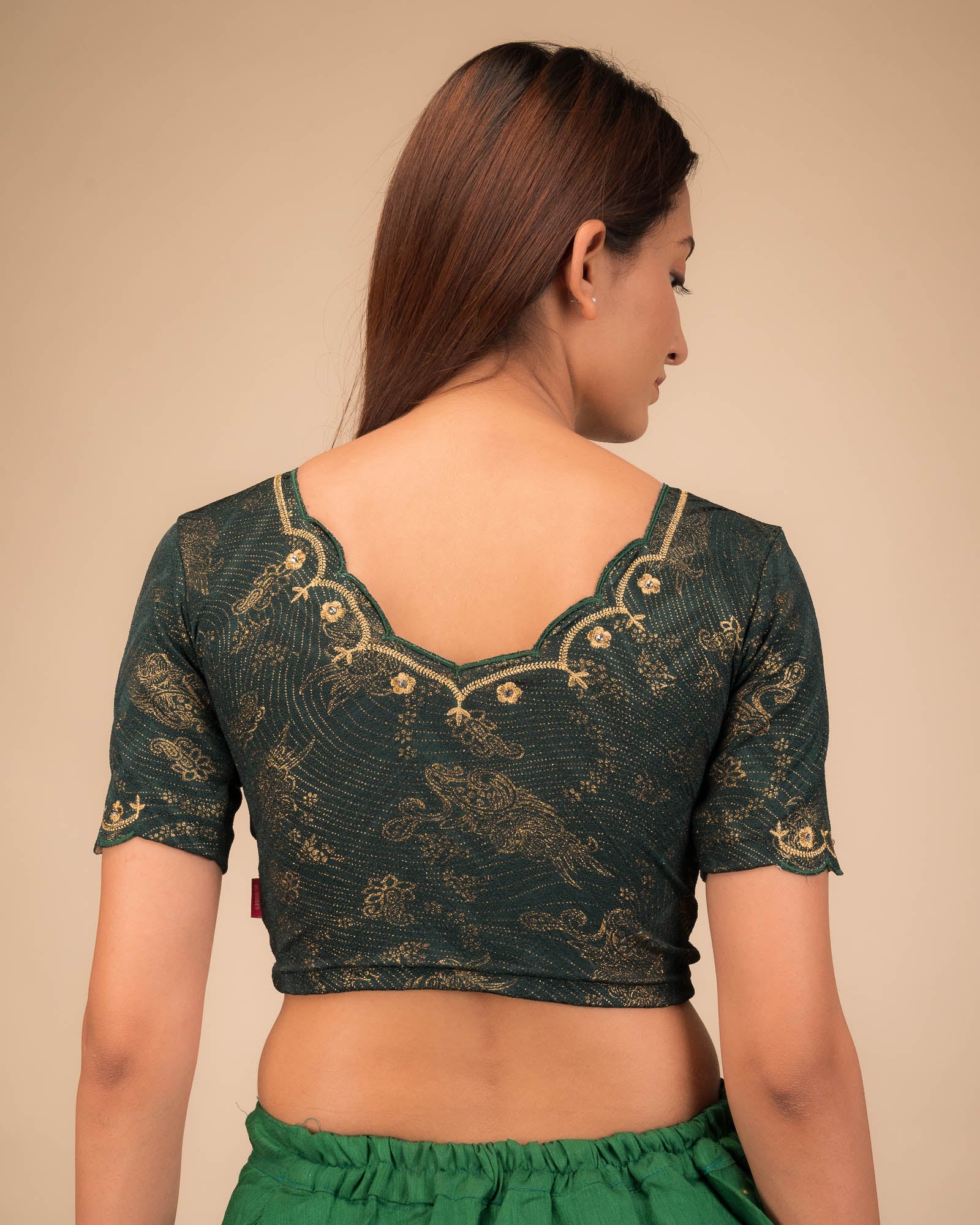 Rear view showing the back design and scallop-edge sleeves.