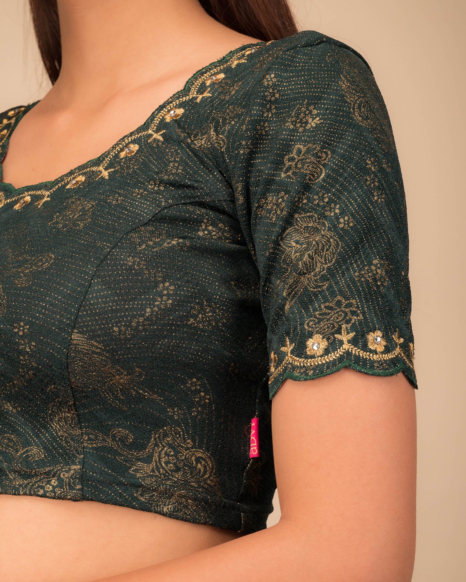 Close-up of jacquard knit with detailed embroidery.
