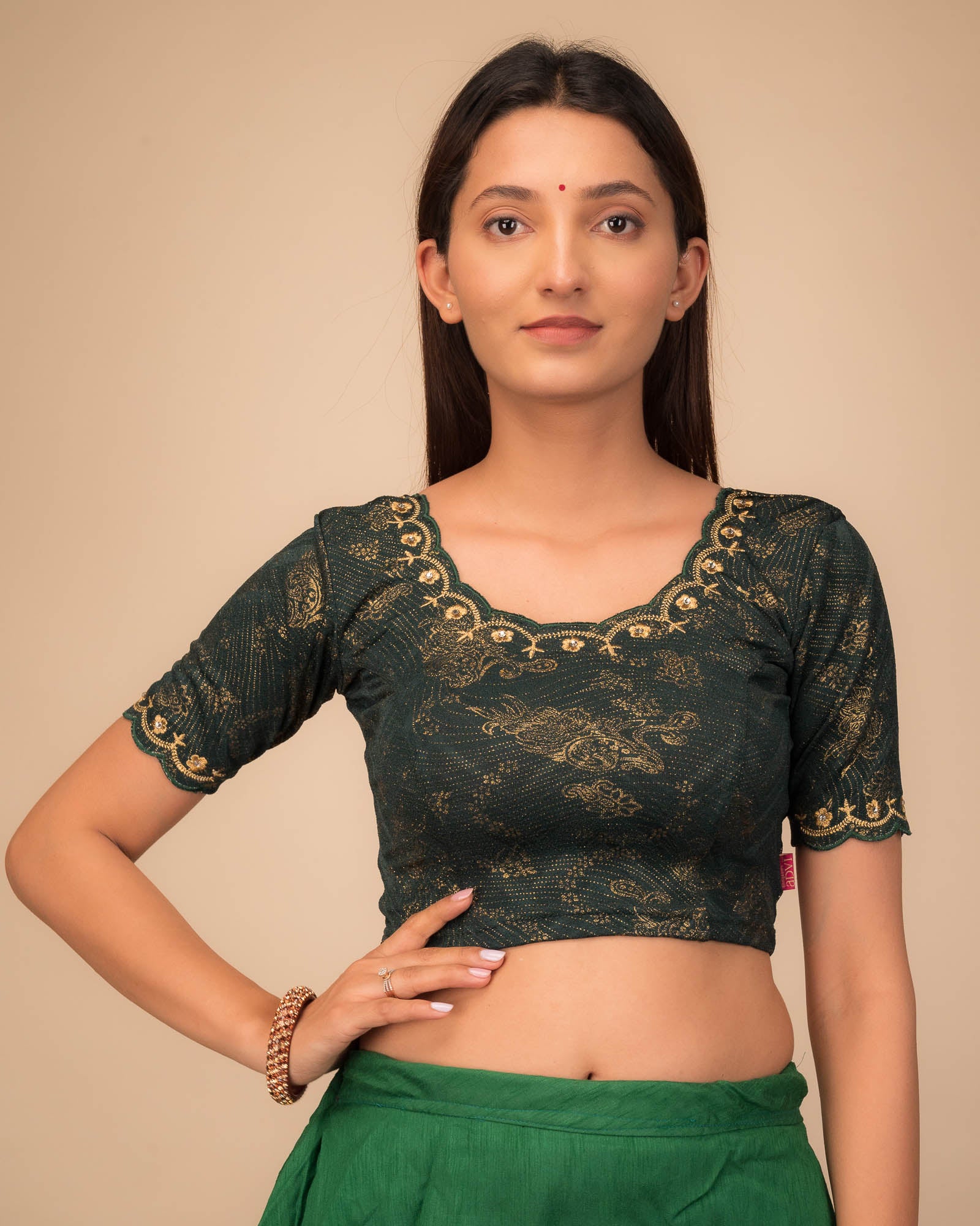 Model wearing a stretchable blouse with scalloped sleeves and round neckline featuring embroidery.