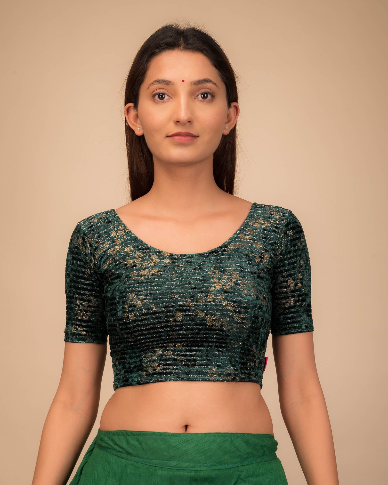 Model wearing a velvet stretchable blouse with elbow sleeves and round neckline.
