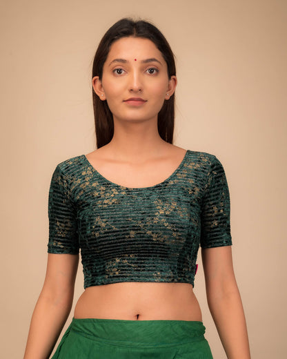 Model wearing a velvet stretchable blouse with elbow sleeves and round neckline.